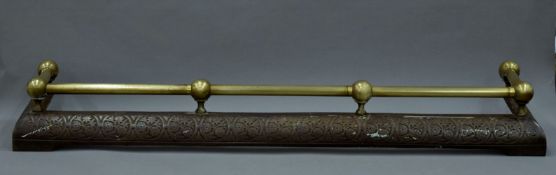 A Victorian brass and iron fender.