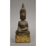 A Thai carved wooden model of Buddha. 17 cm high.