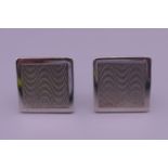 A pair of engine turned silver cufflinks. 1.75 cm square.