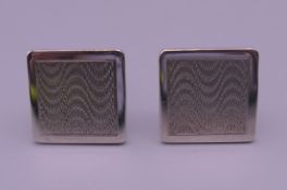 A pair of engine turned silver cufflinks. 1.75 cm square.