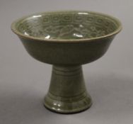 A Chinese celadon porcelain stem cup. 8.5 cm high.