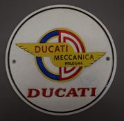 A Ducati cast iron sign. 24.5 cm diameter.