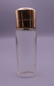 An 18 ct gold topped scent bottle. 8.5 cm high.