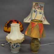 A Galle style glass table lamp and three pottery table lamps. The former 36 cm high.