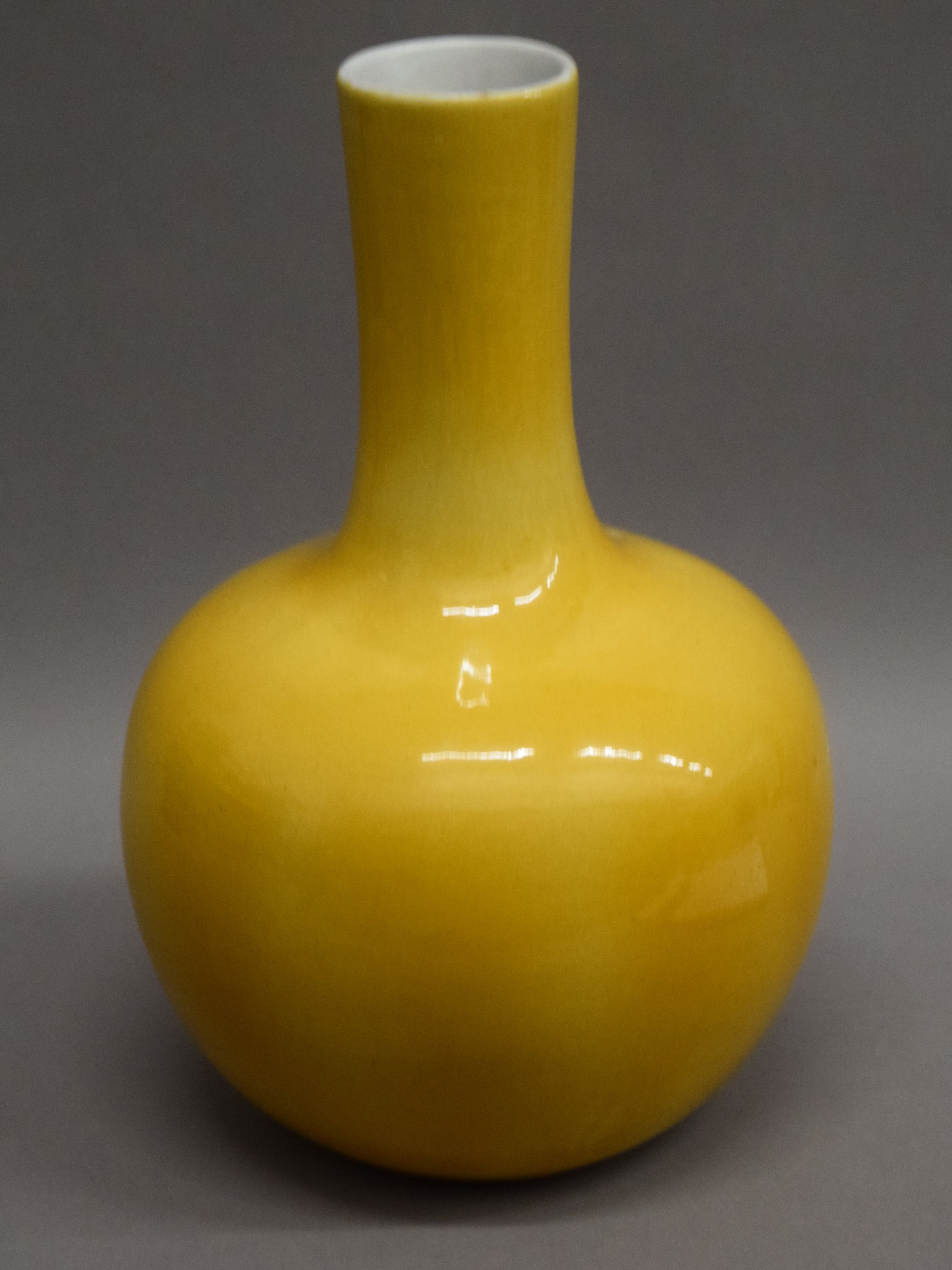 A 19th century Chinese yellow ground vase on a carved wooden stand,