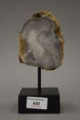 An agate specimen on a display stand. 18 cm high.