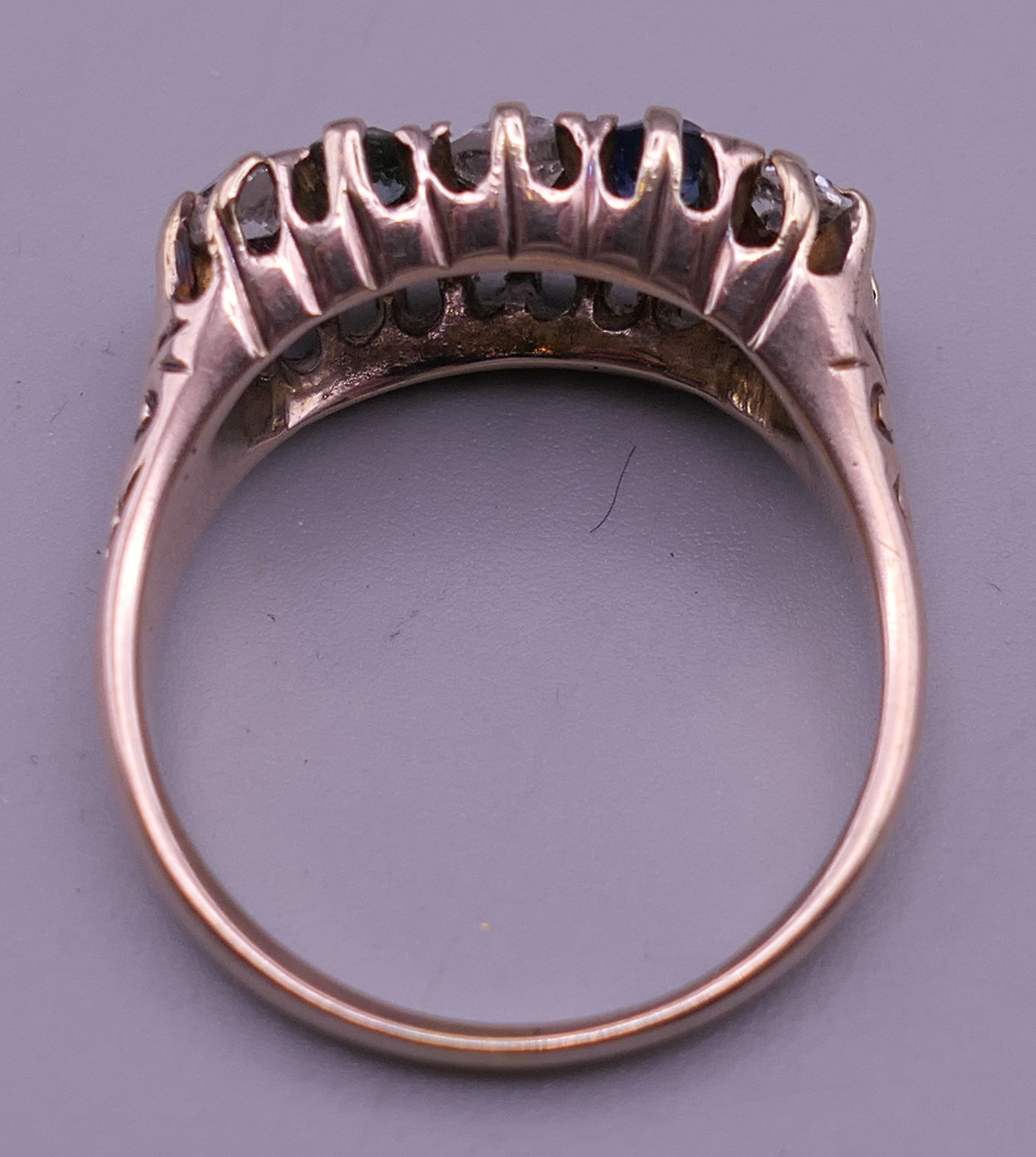 An 18 ct gold diamond and sapphire ring. 8 mm high, 17 mm wide. Ring size Q/R. - Image 6 of 8