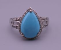 A silver turquoise ring. Ring size T/U.