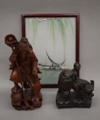 Two Oriental carvings and a framed silk picture. The latter 24 cm high.