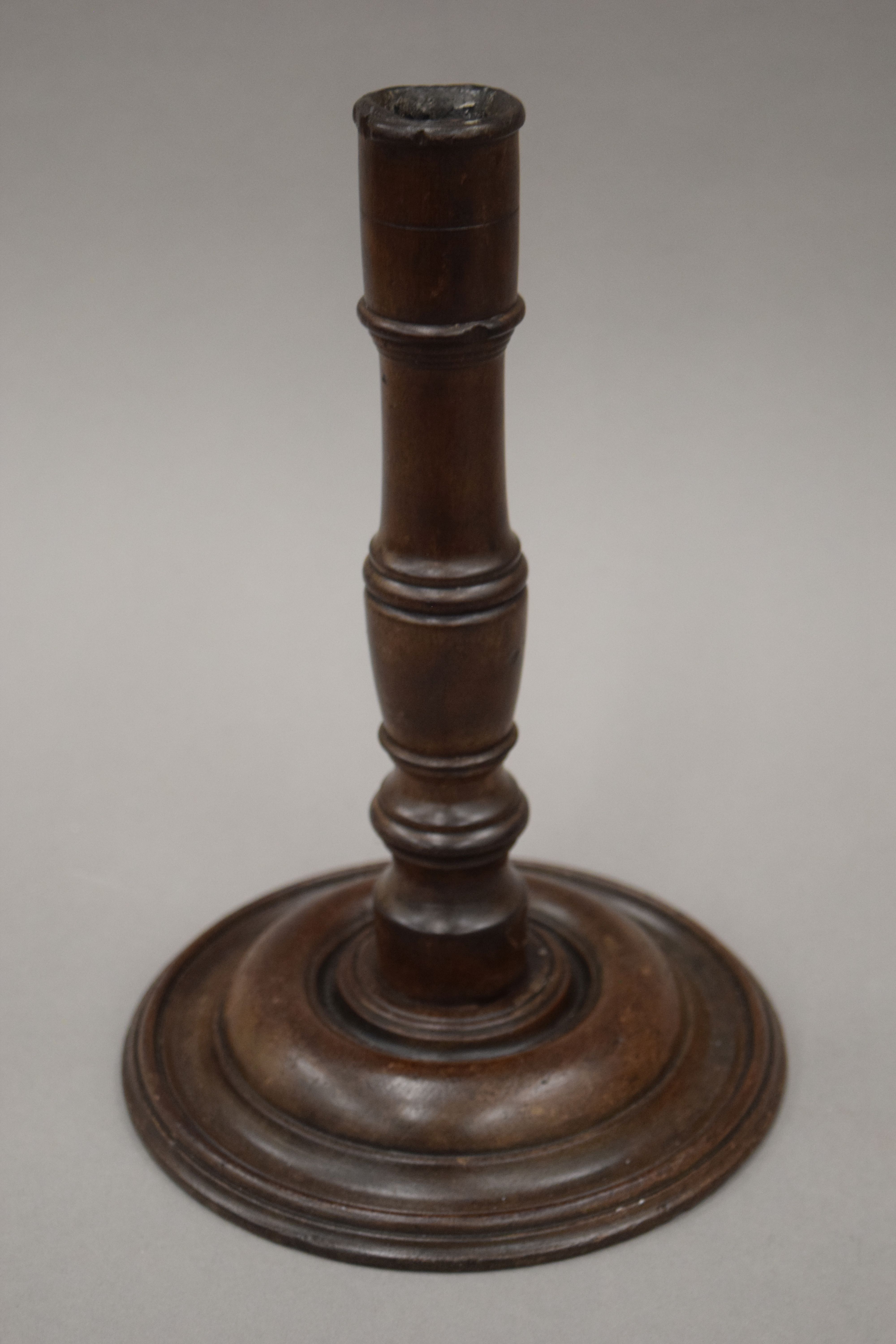 A 19th century turned wooden candlestick. 24.5 cm high.