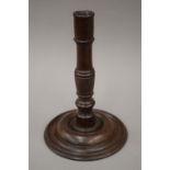 A 19th century turned wooden candlestick. 24.5 cm high.