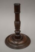 A 19th century turned wooden candlestick. 24.5 cm high.