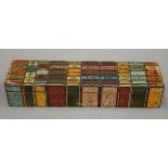 A papier mache pen box formed as a row of books. 20.5 cm long.