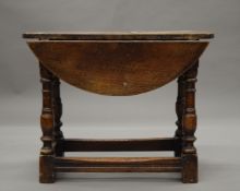 An early 20th century carved oak drop leaf coffee table. 43.5 cm high.