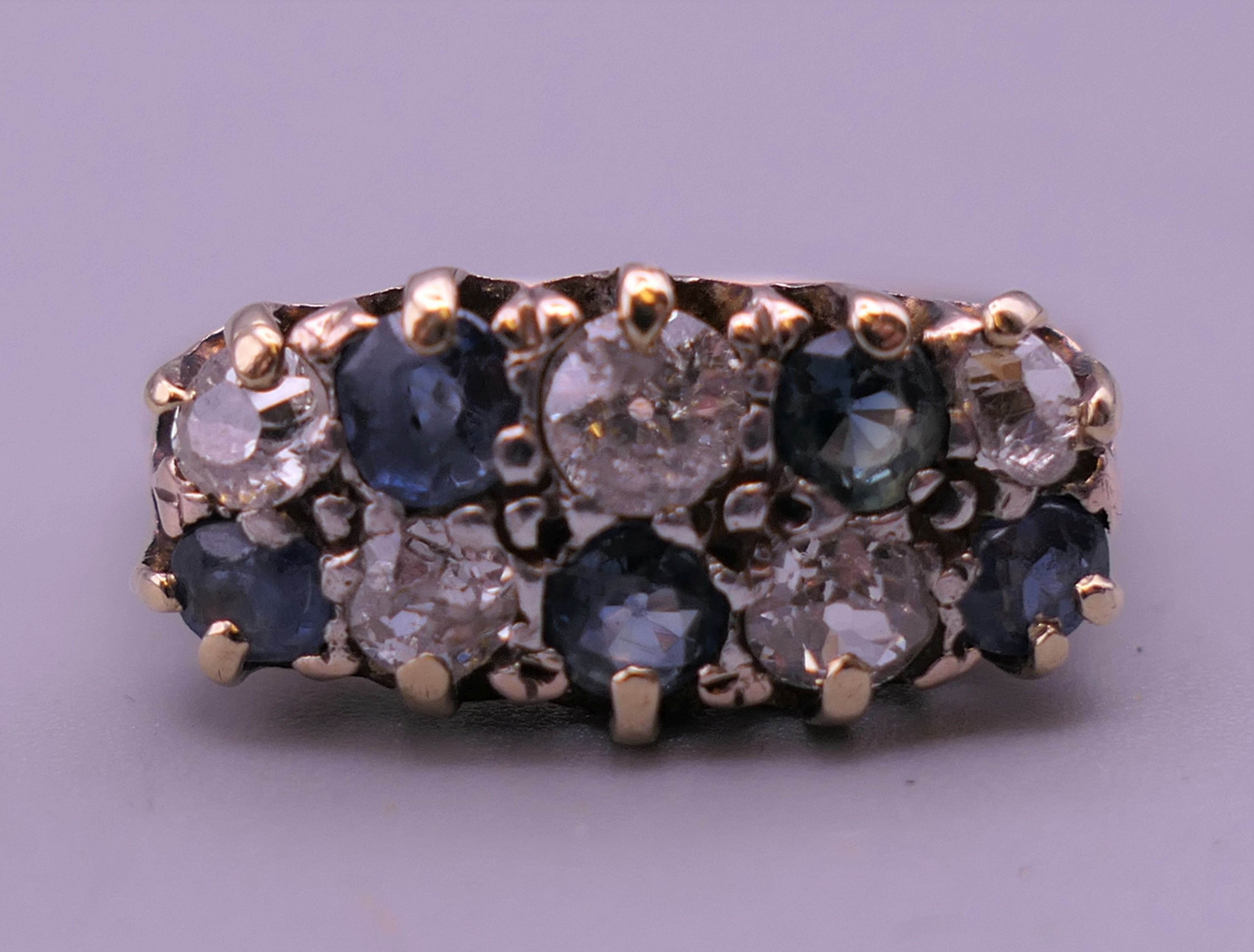 An 18 ct gold diamond and sapphire ring. 8 mm high, 17 mm wide. Ring size Q/R. - Image 8 of 8