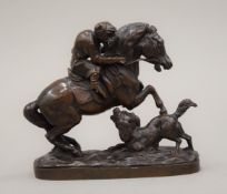 A 19th century bronze model of a monkey riding a horse, indistinctly signed. 10 cm high.