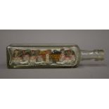 A model village in a bottle. 21.5 cm long.