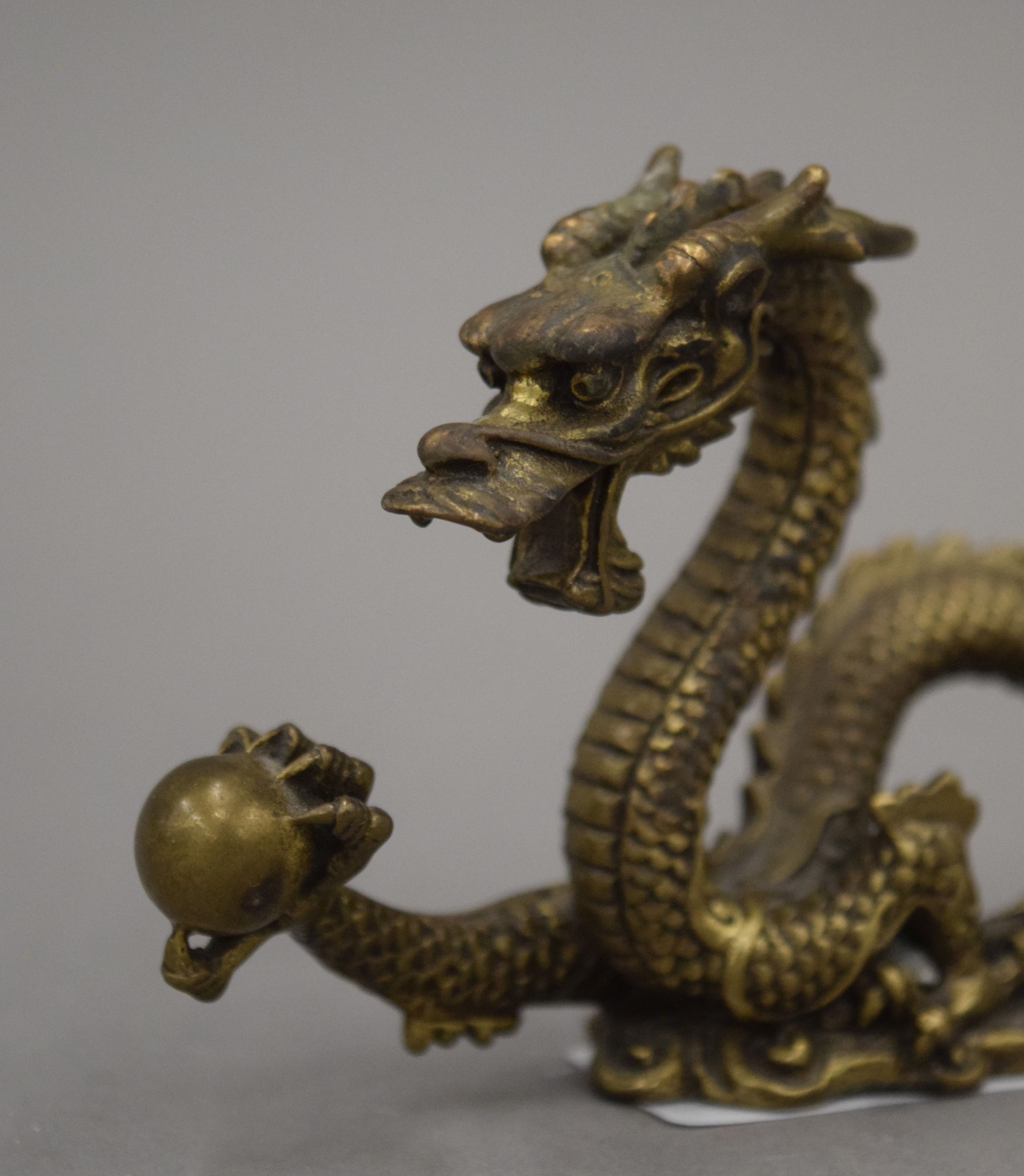 A Chinese gilt bronze dragon brush rest. 7 cm high. - Image 2 of 3