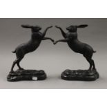 A pair of bronze models of boxing hares. 29 cm high.