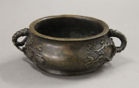 A Chinese bronze censer with bamboo form handles. 18 cm wide.