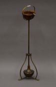 An Art Nouveau brass and turned wooden gimble mounted ashtray stand, possibly from a shipping liner.