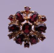 A 9 ct gold garnet ring. Ring size M. 7.1 grammes total weight.