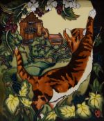 A Moorcroft porcelain plaque decorated with a cat, framed. 26 x 30 cm overall.