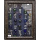 A collection of 19th century glass eye baths, mounted in a box frame. 43 x 56 cm overall.