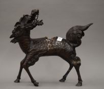 A 19th century Chinese bronze censer formed as a Qilin. 35.5 cm high.