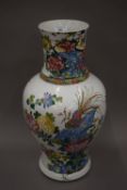 A 19th century Chinese porcelain vase decorated with birds amongst floral sprays. 49 cm high.