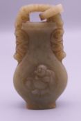 A jade vase form pendant. 6 cm high.