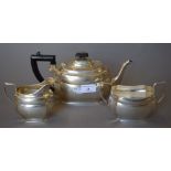 A matched three-piece silver tea set. The teapot 27 cm long. 825.4 grammes total weight.