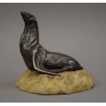 A silvered bronze model of a sea lion mounted on a naturalistic rocky base. 14.5 cm high.