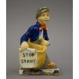 A 1920s General Strike Commemorative match striker formed as a paper boy,