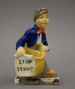 A 1920s General Strike Commemorative match striker formed as a paper boy,