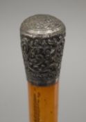 A Victorian malacca walking stick with unmarked Indian silver knop handle. 79.5 cm long.