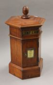 A wooden post box. 44 cm high.