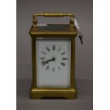 A French brass cased carriage clock. 15 cm high.