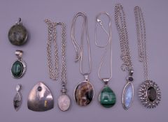 A quantity of silver mounted pendants and chains. 245.8 grammes total weight.