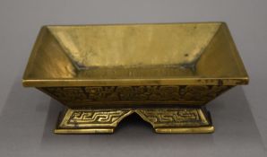 A 19th century Chinese bronze censer of rectangular form with flaring side and two side handles