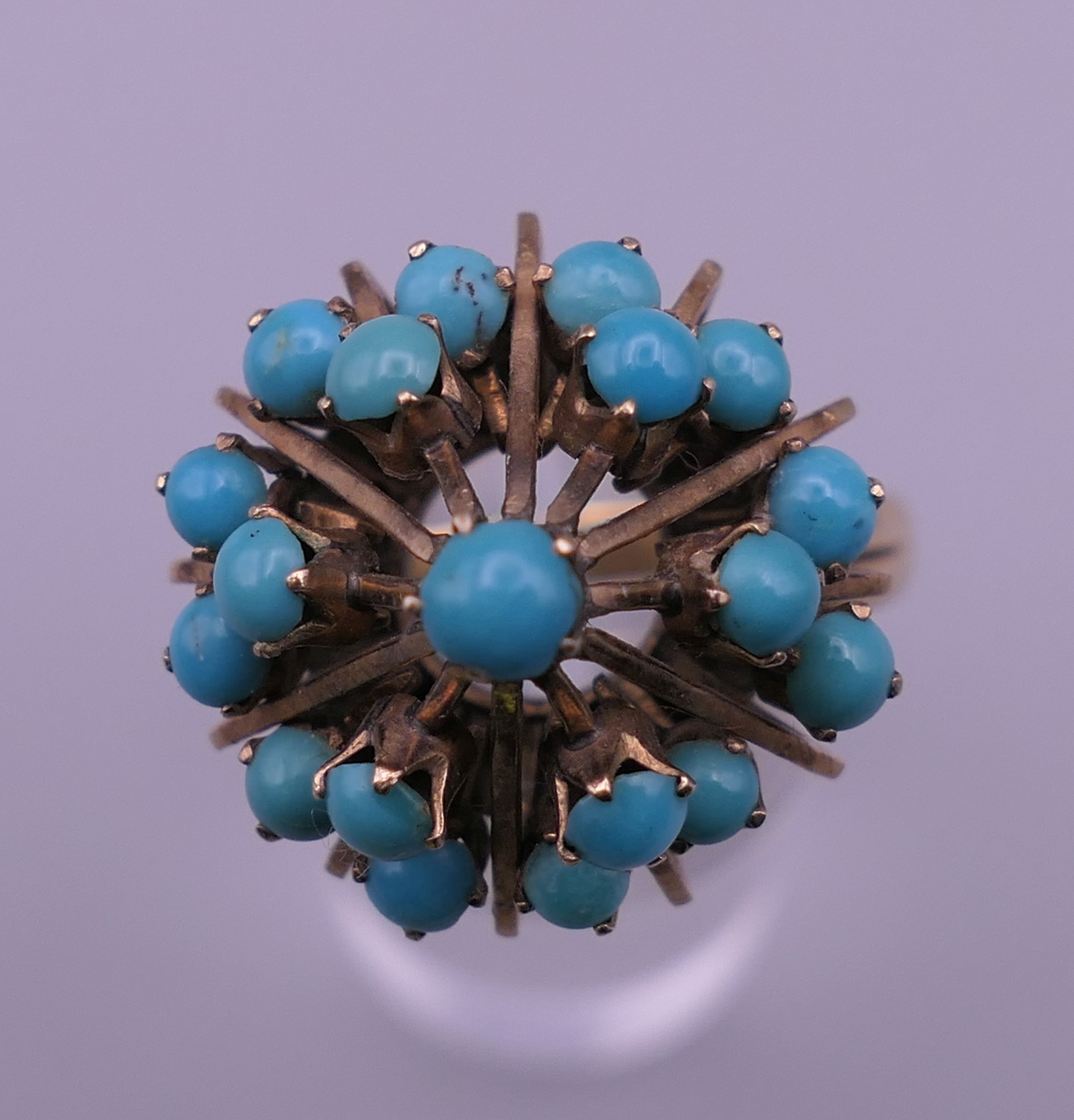 A 14 K gold and turquoise ring. Ring size U. 7.5 grammes total weight.