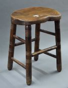A late 19th/early 20th century elm seated stool. 51 cm high.