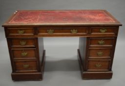 A Victorian walnut pedestal desk. 122.5 cm wide.