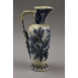 A Martinware jug decorated with birds and a lizard. 23.5 cm high.