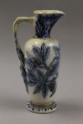 A Martinware jug decorated with birds and a lizard. 23.5 cm high.