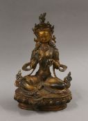 A gilt bronze model of Buddha decorated with coral and turquoise. 21.5 cm high.