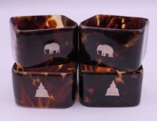 A set of four early 20th century Indian tortoiseshell napkin rings with silver inlay.