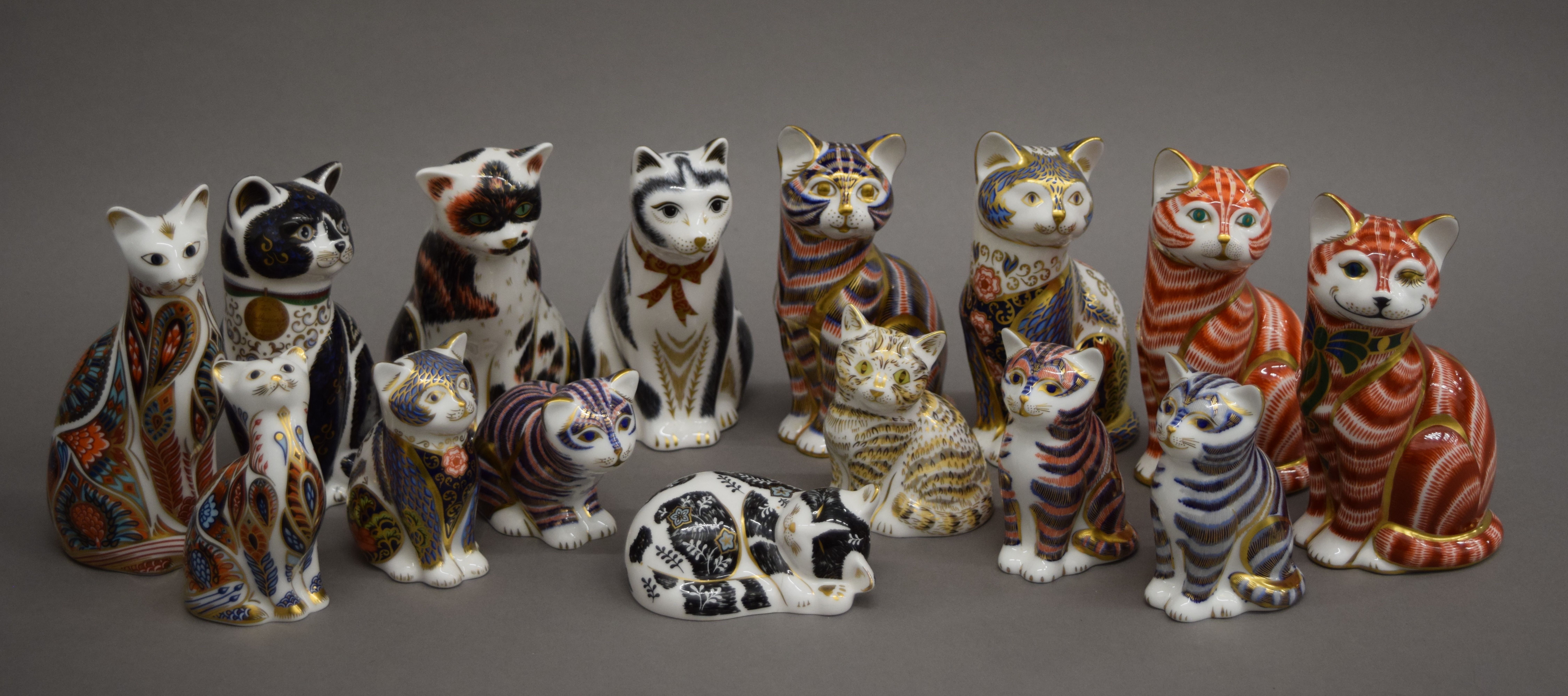A collection of Royal Crown Derby cat form paperweights. The largest 13 cm high.