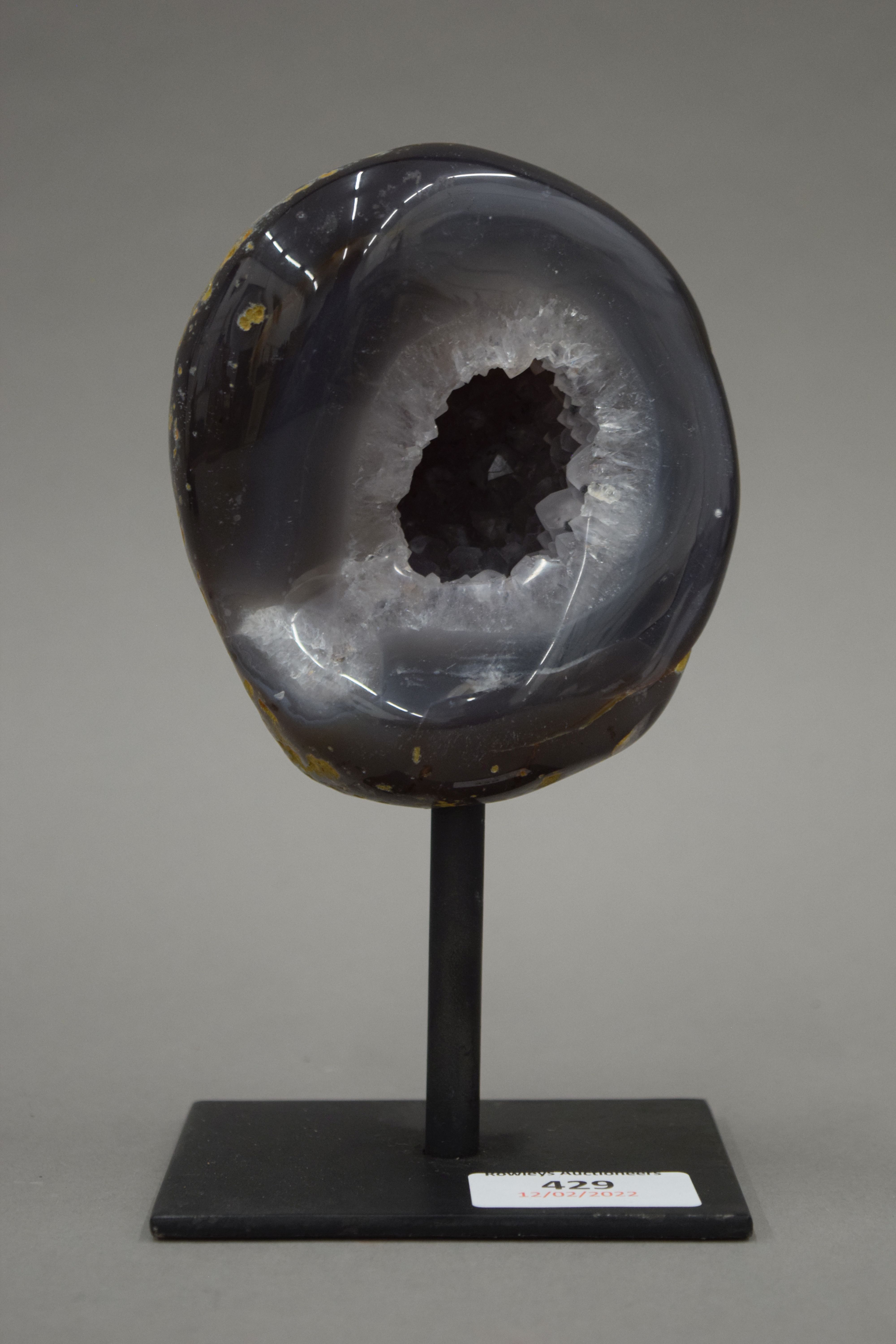 A small mineral geode on presentation stand. 17 cm high overall.