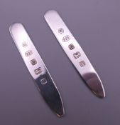 A pair of silver collar stiffeners. 6.5 cm long.